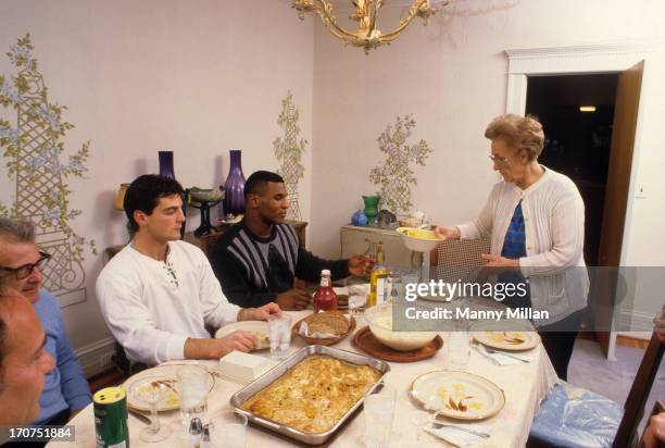 Portrait of Mike Tyson eating dinner with his surrogate mother, Camille Ewald , during photo shoot in her house. Catskill, NY 12/1/1985 CREDIT: Manny...