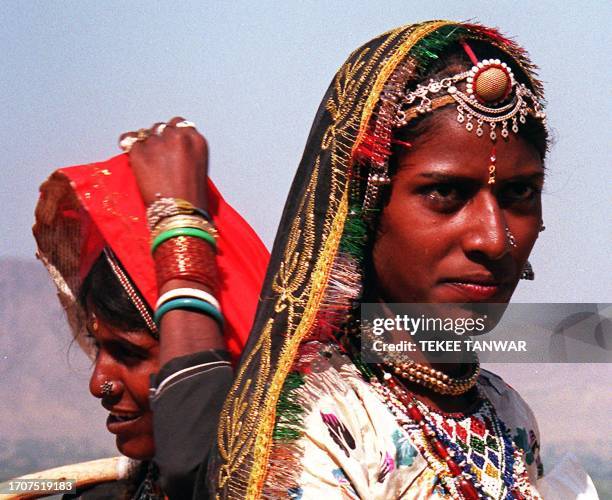 Two woman from the Kalbelia or dancing tribe are pictured 14 November during the annual Pushkar Mela in India's northwestern desert state of...