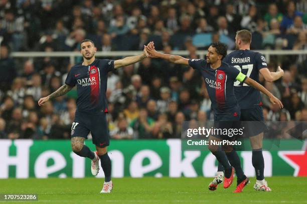 Lucas Hernandez of Paris st Germain high fives Marquinhos after pulling a goal back during the UEFA Champions League Group F match between Newcastle...