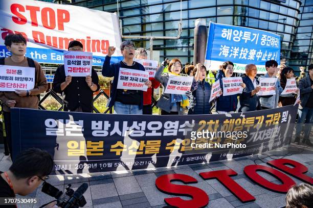 Members of the Joint Action to Stop Japan's Ocean Dumping of Contaminated Water shout slogans during a protest opposing the second ocean dumping of...