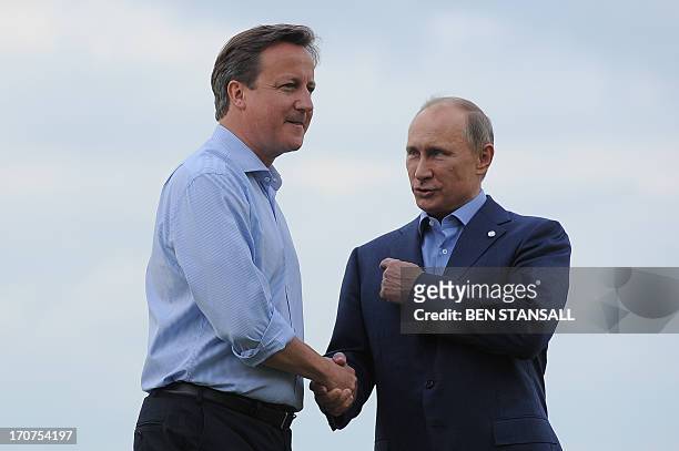 British Prime Minister David Cameron greets Russia's President Vladimir Putin during the official arrrivals for the start of the G8 Summit in at the...