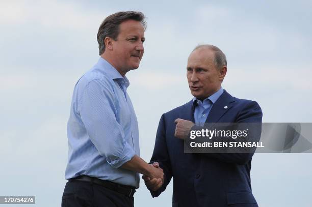 British Prime Minister David Cameron greets Russia's President Vladimir Putin during the official arrrivals for the start of the G8 Summit in at the...