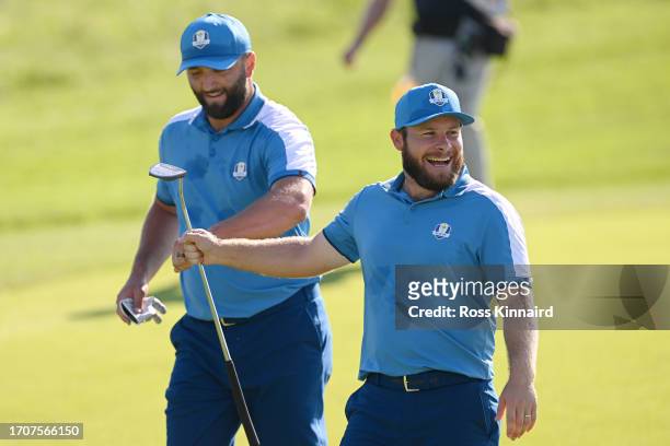 Jon Rahm and Tyrrell Hatton of Team Europe celebrate on the 12th hole during the Friday morning foursomes matches of the 2023 Ryder Cup at Marco...