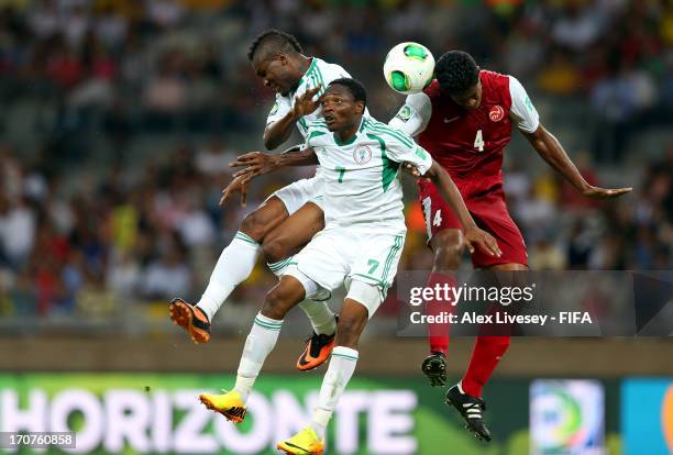 Brown Ideye and Ahmed Musa of Nigeria go up for a header with Teheivarii Ludivion of Tahiti during the FIFA Confederations Cup Brazil 2013 Group B...