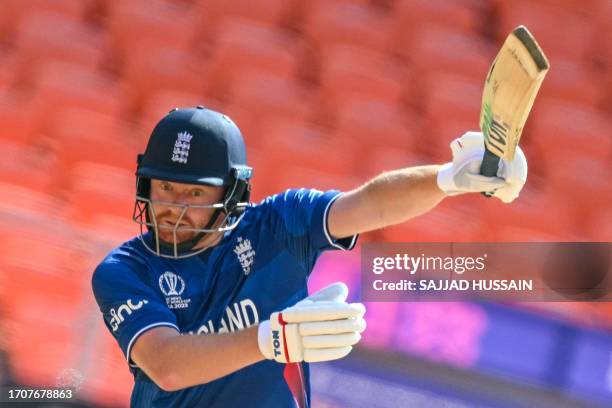 England's Jonny Bairstow watches the ball after playing a shot during the 2023 ICC men's cricket World Cup one-day international match between...