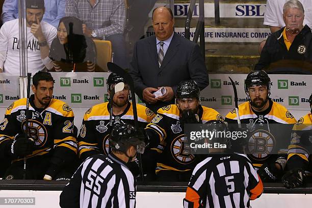 Head coach Claude Julien of the Boston Bruins looks on with his team as linesman Shane Heyer and referee Chris Rooney approach in Game Three of the...