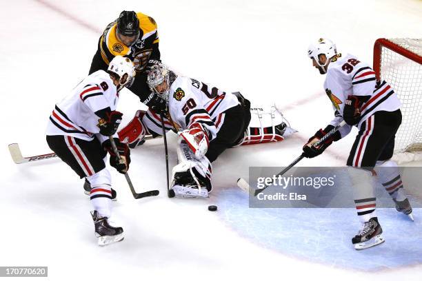 Corey Crawford of the Chicago Blackhawks tends goal against Rich Peverley of the Boston Bruins in Game Three of the 2013 NHL Stanley Cup Final at TD...