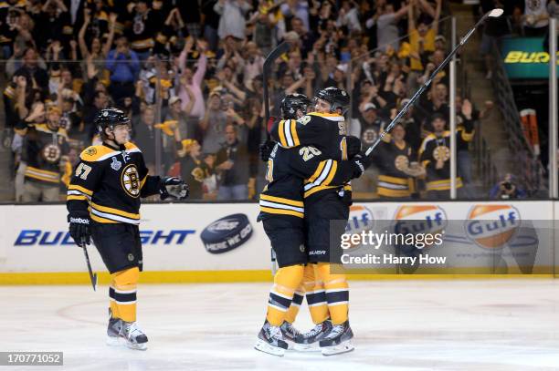 Daniel Paille of the Boston Bruins celebrates with Tyler Seguin and Torey Krug after scoring in the second period against the Chicago Blackhawks in...