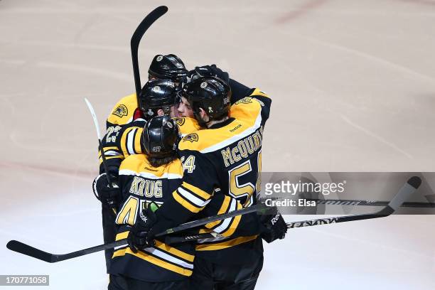 Daniel Paille of the Boston Bruins celebrates with Chris Kelly, Torey Krug and Adam McQuaid after scoring in the second period against the Chicago...