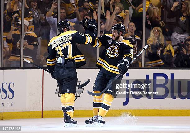 Patrice Bergeron of the Boston Bruins celebrates with Tyler Seguin after Bergeron scores in the second period against the Chicago Blackhawks in Game...