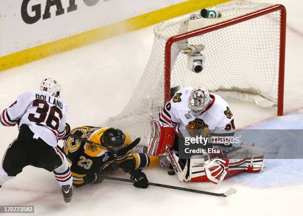 Corey Crawford of the Chicago Blackhawks stops a shot by Chris Kelly of the Boston Bruins in Game Three of the 2013 NHL Stanley Cup Final at TD...