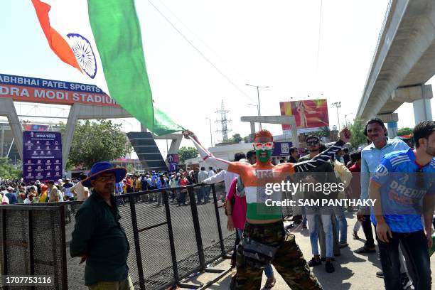 Fan waves India's national flag as he arrives to watch the 2023 ICC men's cricket World Cup one-day international match between England and New...