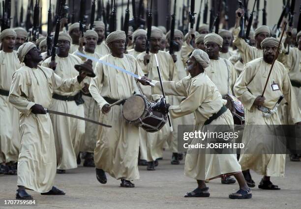 Omani tribesmen march during a parade at a stadium in Muscat marking 40 years since Omani ruler Sultan Qaboos bin Said took the throne on November...