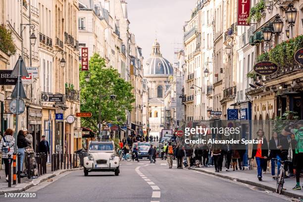 crowded street with cafes and restaurants in latin quarter on a sunny day, paris, france - crowded cafe stock pictures, royalty-free photos & images