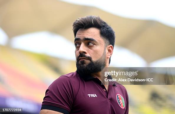 62 R Khan Rashid Khan of Afghanistan inspects the pitch after the match is ...