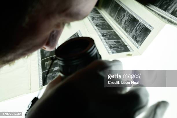 Julian Ridgway, Managing Editor - Archive, using a loupe to select frames from a strip of negatives while editing at the Getty Images Hulton Archive,...