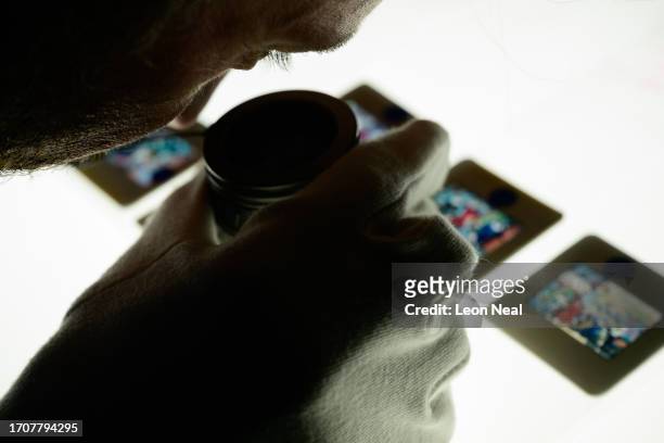 Julian Ridgway, Managing Editor - Archive, using a loupe to select transparencies at the Getty Images Hulton Archive, London, E16, 21st September...