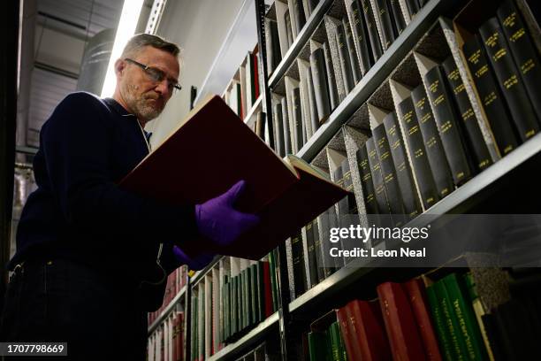 Archival Search Editor Jim Nye looking through a day book from the Topical Press Agency at the Getty Images Hulton Archive, London, E16, 21st...