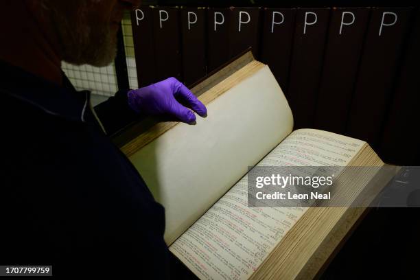 Archival Search Editor Jim Nye looking through a day book from the Topical Press Agency at the Getty Images Hulton Archive, London, E16, 21st...