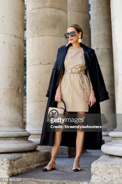 Influencer Alexandra Lapp, wearing a black Massimo Dutti oversized leather coat, a beige Louis Vuitton dress and bag, Chanel ballerinas, For Arts...