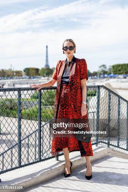 Influencer Alexandra Lapp, wearing a Maison Common short sleeve long duster in orange, a Maison Common silk satin stretch shell top in black, a...