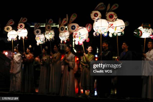 People parade with rabbit-shaped lanterns at Hongcun Village to welcome the upcoming Mid-Autumn Festival on September 28, 2023 in Huangshan City,...