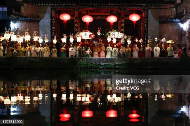 People parade with rabbit-shaped lanterns at Hongcun Village to welcome the upcoming Mid-Autumn Festival on September 28, 2023 in Huangshan City,...