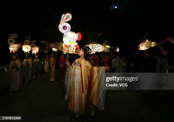 People parade with rabbit-shaped lanterns at Hongcun Village to welcome the upcoming Mid-Autumn Festival on September 28, 2023 in Huangshan City,...