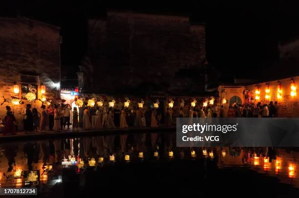 People parade with rabbit-shaped lanterns at Hongcun Village to welcome the upcoming Mid-Autumn Festival on September 28, 2023 in Huangshan City,...