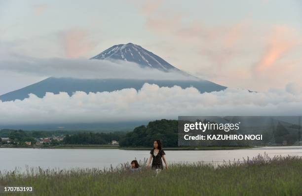 This picture taken on June 16, 2013 shows Mount Fuji, the highest mountain in Japan at 3,776 metres , and Lake Kawaguchi in Fujikawaguchiko, southern...