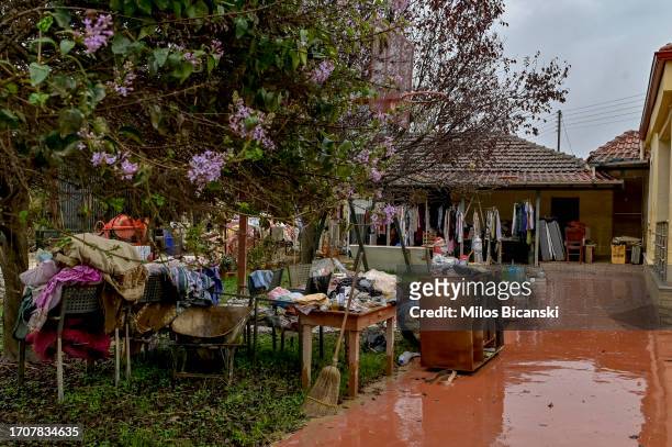 Removed furniture and family belongings are laid outside a flooded house in the village of Metamorfosi, still covered in mud in the village which had...