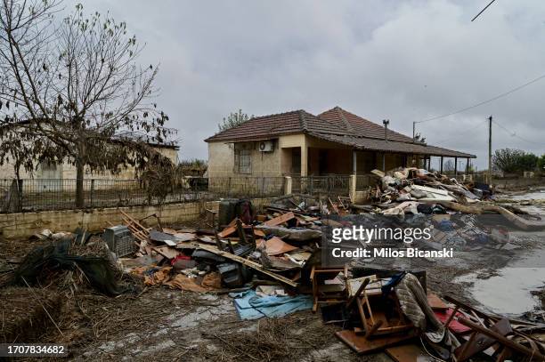 Removed furniture and family belongings are laid outside a flooded house in the village of Metamorfosi, still covered in mud in the village which had...