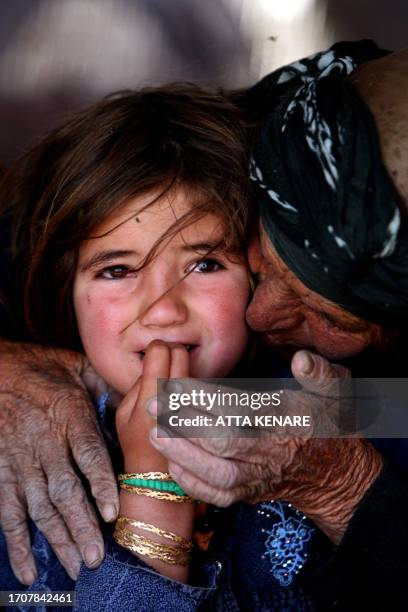 An elderly woman from the Qashqai tribe speaks with her granddaughter inside their tent in Eghlid in the southern Iranian province of Fars on July 8,...