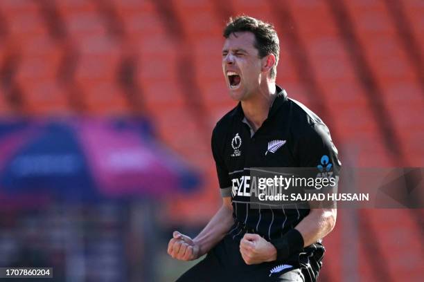 New Zealand's Matt Henry celebrates after taking the wicket of England's captain Jos Buttler during the 2023 ICC men's cricket World Cup one-day...