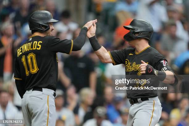 Henry Davis of the Pittsburgh Pirates celebrates with Bryan Reynolds after hitting a two-run home run in the second inning against the Milwaukee...