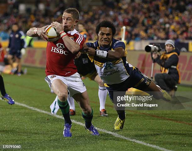 Shane Williams of the Lions is tackled by Henry Speight during the International tour match between the ACT Brumbies and the British & Irish Lions at...