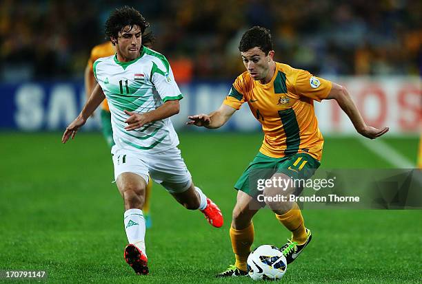 Tommy Oar of Australia competes with Humam Tareq Faraj of Iraq during the FIFA 2014 World Cup Asian Qualifier match between the Australian Socceroos...