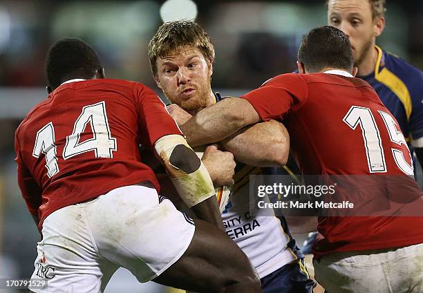 Clyde Rathbone of the Brumbies is tackled during the International tour match between the ACT Brumbies and the British & Irish Lions at Canberra...