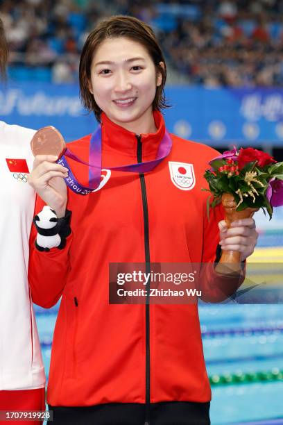 Bronze medal Ikee Rikako of Japan attends the award ceremony after Women's 50m Butterfly Final at Hangzhou Olympic Sports Centre, Aquatic Sports...