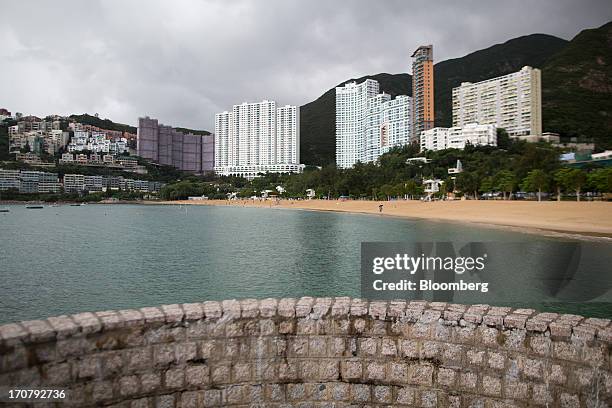 Residential buildings stand along the waterfront in the Repulse Bay area of Hong Kong, China, on Sunday, June 16, 2013. A shortage of housing, low...