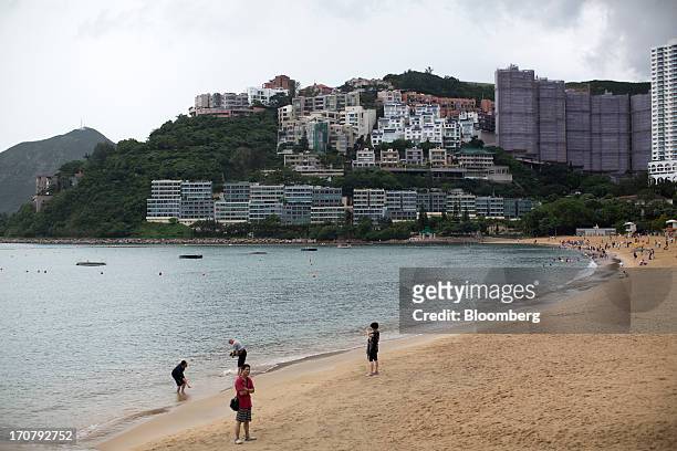 Residential buildings stand along the waterfront next to Repulse Bay beach in Hong Kong, China, on Sunday, June 16, 2013. A shortage of housing, low...