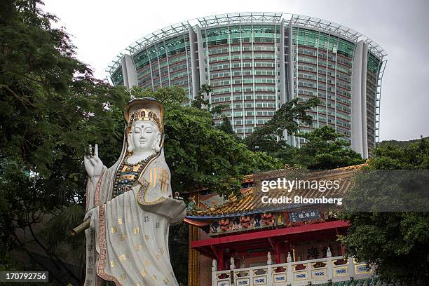 Statue of Tin Hau, the goddess of the sea, stands at a Taoist temple in front of the Lily, a residential building, in the Repulse Bay area of Hong...