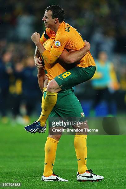 Lucas Neill and Luke Wilkshere of Australia celebrate at full time after victory over Iraq during the FIFA 2014 World Cup Asian Qualifier match...
