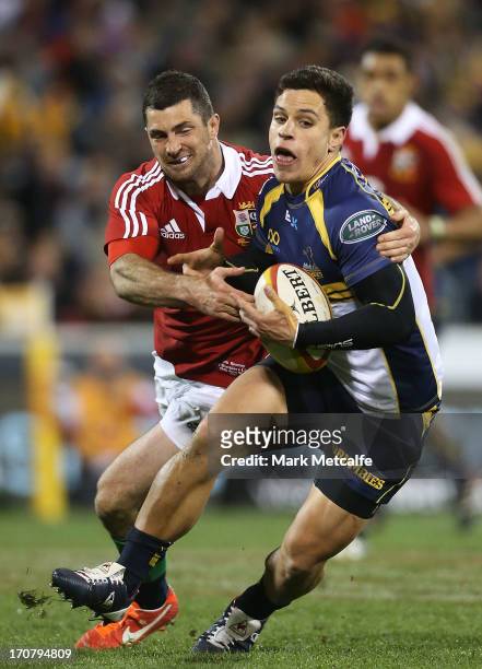 Matt Toomua of the Brumbies is tackled by Rob Kearney of the Lions during the International tour match between the ACT Brumbies and the British &...