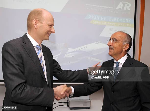 The chief executive officer of the European turboprop manufacturer ATR, Filippo Bagnato , shakes hands on June 18, 2013 with the chairman of the...
