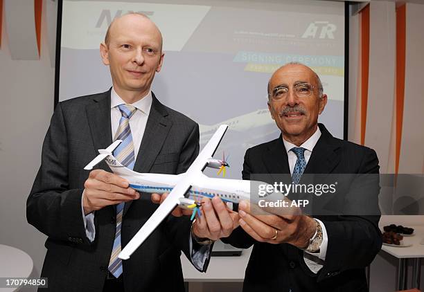 The chief executive officer of the European turboprop manufacturer ATR, Filippo Bagnato , poses on June 18, 2013 with the chairman of the Danish...