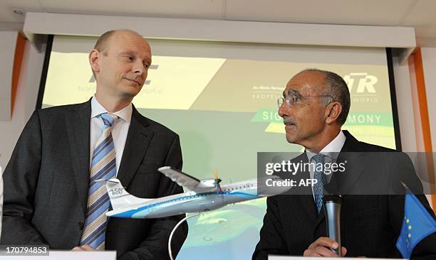 The chief executive officer of the European turboprop manufacturer ATR, Filippo Bagnato , shakes hands on June 18, 2013 with the chairman of the...