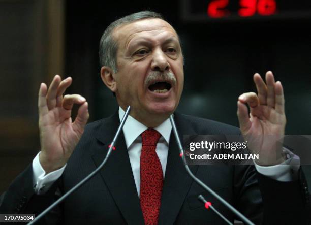 Turkish Prime Minister Recep Tayyip Erdogan is applauded as he arrives to address on June 18, 2013 deputies of his ruling Justice and Development...