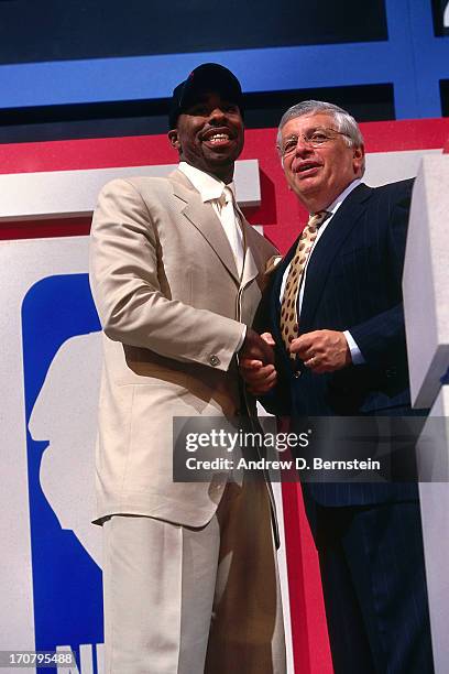 Mateen Cleaves shakes hands with NBA Commissioner David Stern after he was selected number fourteen overall by the Detroit Pistons during the 2000...