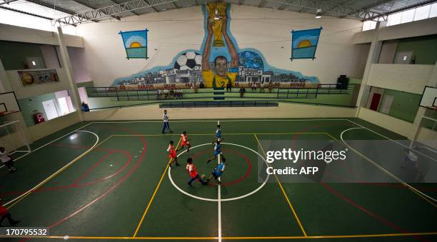 Children play futsal at the Cafu Foundation, on June 8 in Sao Paulo, Brazil. The Cafu Foundation was conceived by Brazilian former football player...